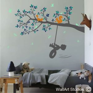 Little Boy Swinging on Tree Branch