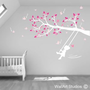 Little Girl Swinging on Tree Branch